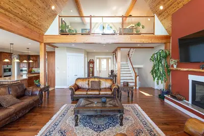 a living room with a couch and a table at Blue Horizon Mountain Retreat B&B in Shawnigan Lake