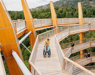 a man riding a stroller on a bridge at Blue Horizon Mountain Retreat B&B in Shawnigan Lake