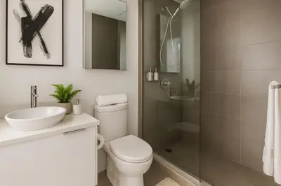 a bathroom with a toilet sink and a shower at Premium 2BR Condo Wide Mountain Panorama in Vancouver