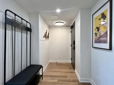 a hallway with a black bench in a room at Luxury 2 Bedroom Mountain View Condo in Canmore