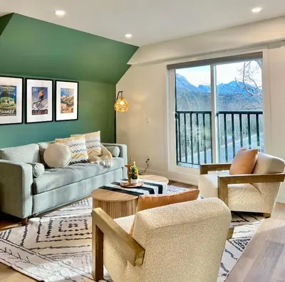 a living room with a couch and chairs and a window at Luxury 2 Bedroom Mountain View Condo in Canmore