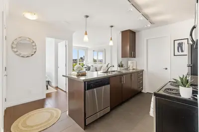 a kitchen with a sink and a counter at Sunny Corner 1-Bedroom Chinatown and Gastown at Your Doorstep in Vancouver