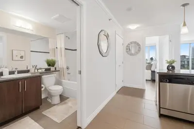 a white bathroom with a toilet and a sink at Sunny Corner 1-Bedroom Chinatown and Gastown at Your Doorstep in Vancouver