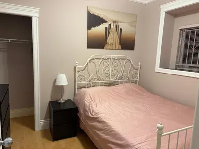 a bedroom with a bed and a picture on the wall at Vacation Home in Vancouver