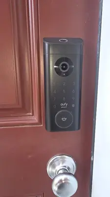 a door with a remote control on a wooden door at Home Away From Home With Free Netflix, Prime and Paramount in Calgary