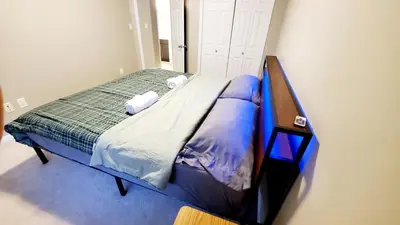 a bedroom with a bed in a room at Entertainment house with 2 king 1 queen 1 sofa bed In-house Theater Attach Garage Near YEG Loved by Guests on Other Plateform in Edmonton