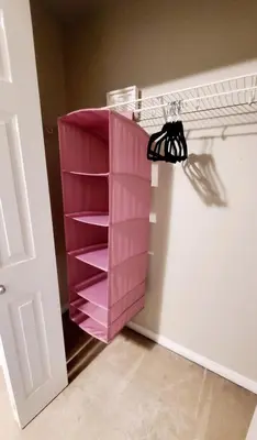 a pink book shelf in a room next to a door at Entertainment house with 2 king 1 queen 1 sofa bed In-house Theater Attach Garage Near YEG Loved by Guests on Other Plateform in Edmonton