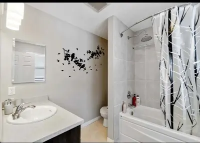 a white bathroom with a sink and a shower at Entertainment house with 2 king 1 queen 1 sofa bed In-house Theater Attach Garage Near YEG Loved by Guests on Other Plateform in Edmonton