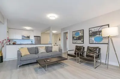 a living room with a couch and chairs and a table at Spacious Oceanview Suite with Private Entrance in West Vancouver