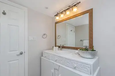 a bathroom with a sink and a mirror at Spacious Oceanview Suite with Private Entrance in West Vancouver