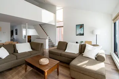 a living room with two couches and a table at Unit 33 - 4 bedrooms - Sleeps 10 in Bélanger