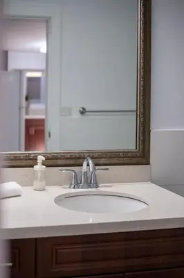 a bathroom counter with a sink and a mirror at Cozy 2B Suite in Great Location Near Trails & Shop in North Vancouver