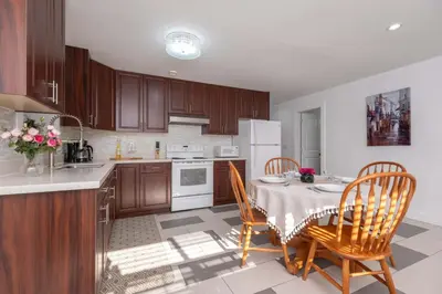a kitchen with a table and chairs in a kitchen at Cozy 2B Suite in Great Location Near Trails & Shop in North Vancouver