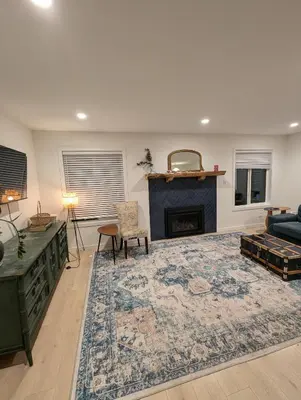 a living room with a fireplace and a couch at Colwood Hidden Home in Colwood