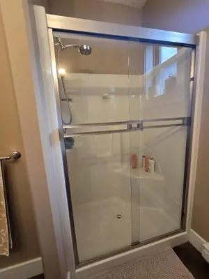 a shower with a glass door in a bathroom at Bright Private Room in Echo Valley Home in Victoria