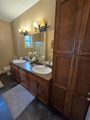 a bathroom with two sinks and a large mirror at Bright Private Room in Echo Valley Home in Victoria