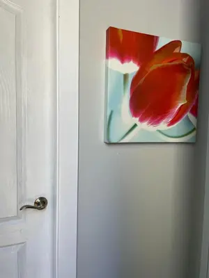 a picture of a red flower on a door at Surrey Home - King George Blvd & Rapid Transit - Airport 25 Min - Free Parking & Wi-Fi in Surrey