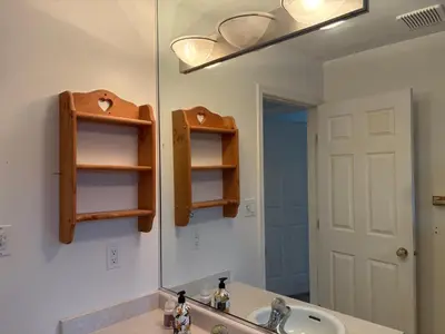 a bathroom with a sink and a mirror at Vancouver Guest House - Airport & Downtown 15 Min - Free Parking & Fast Wi-Fi in Vancouver