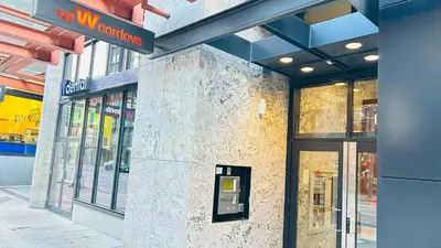 a building with a pay phone on the side of it at Ocean and Mountain View Home - Downtown Vancouver in Vancouver