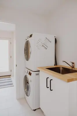 a kitchen with two washing machines and a sink at Luxury 1BR at Red Mountain Ski-Bike Sauna in Rossland