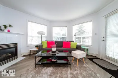 a living room with a couch and a fireplace at The Neon Palace - King Bed - Fireplace - Netflix - UGPark in Edmonton