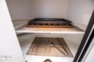 a drawer in a refrigerator with a pan on it at The Neon Palace - King Bed - Fireplace - Netflix - UGPark in Edmonton