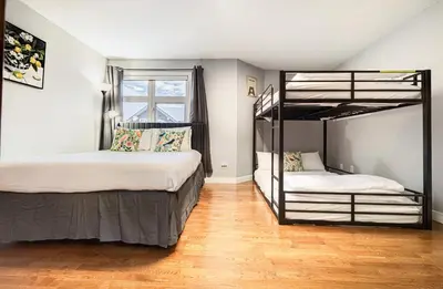 a bedroom with two bunk beds and a window at Rocky Mountain Retreat-Mountain View! in Canmore