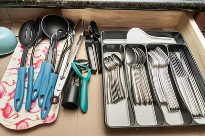 a drawer filled with utensils on a table at Rocky Mountain Retreat-Mountain View! in Canmore