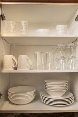 a shelf filled with dishes and glass jars at Rocky Mountain Retreat-Mountain View! in Canmore