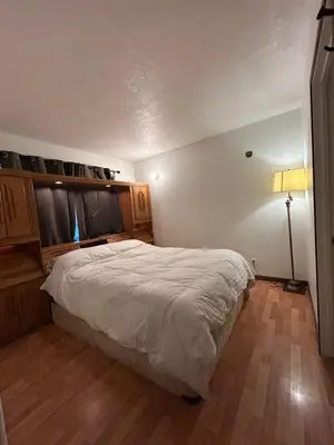 a bedroom with a bed and a lamp in it at 3 Bedroom Townhouse in McBride