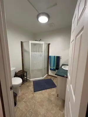 a bathroom with a shower and a toilet and a sink at 3 Bedroom Townhouse in McBride