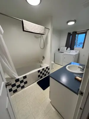 a bathroom with a sink and a tub and a toilet at 3 Bedroom Townhouse in McBride