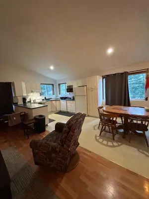 a kitchen and dining room with a table and chairs at 3 Bedroom Townhouse in McBride