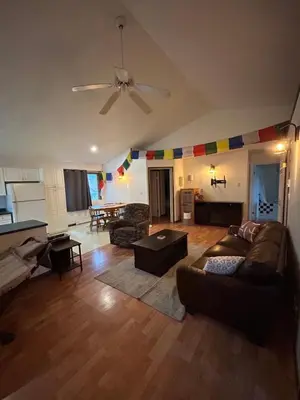 a living room with a couch and a ceiling fan at 3 Bedroom Townhouse in McBride