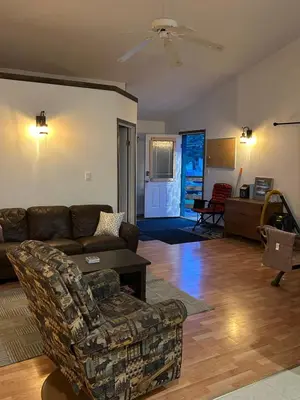 a living room with a couch and a chair at 3 Bedroom Townhouse in McBride