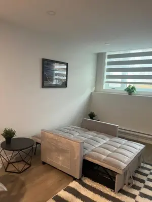 a bedroom with a large bed and a window at Livingston Calgary Lovely space in Calgary