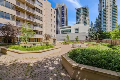 a park in the middle of a city with tall buildings at Chic & Spacious 2BR at Stampede with Parking, AC in Calgary