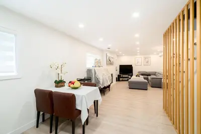 a living room with a table and a couch at Modern Private 2 BR with 1 bath, 3 beds, West Van in West Vancouver
