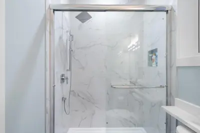 a bathroom with a shower with a glass door at 2393 Bonaccord Dr - Mattamel in Vancouver