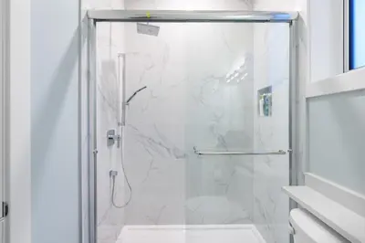 a shower with a glass door in a bathroom at 2393 Bonaccord Dr - Mattamel in Vancouver