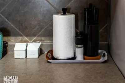 a roll of paper towels sitting on a counter at The Breakfast Club Suite - KingBed& AC - Patio - UG Park in Edmonton
