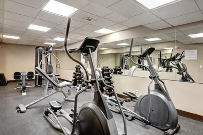 a gym with several exercise bikes in a room at Silver Creek 2BR Bliss Hot Tub Access MTN Views in Canmore