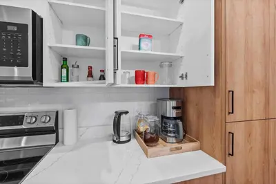 a kitchen with a coffee maker on a counter at Luxurious Large 3 Bedroom Loft Saskatchewan Drive in Edmonton