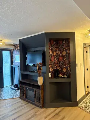 a living room with a flat screen tv on a wall at Cozy boho downtown apartment in Calgary