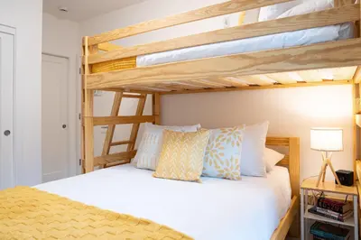 two bunk beds in a room with a bed at Bluebird by Revelstoke Vacations in Revelstoke