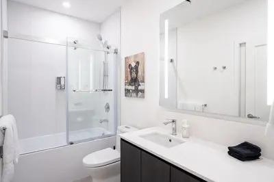 a bathroom with a sink and a toilet and a shower at Bluebird by Revelstoke Vacations in Revelstoke