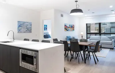 a kitchen and dining room with a table and chairs at Bluebird by Revelstoke Vacations in Revelstoke