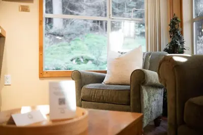 a living room with a couch and a table at Wildwood Lodge 113 by Outpost Whistler in Whistler