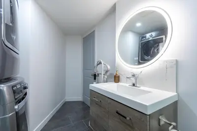 a bathroom with a sink and a mirror at Cozy Quiet Suite - 2 Bedrooms and 2 Full Bathrooms in Calgary