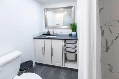 a bathroom with a sink and a mirror at Cozy Quiet Suite - 2 Bedrooms and 2 Full Bathrooms in Calgary